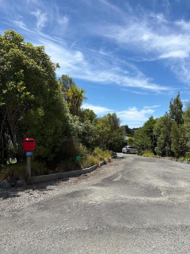 a street with a red mailbox on the side of the road at Dawson Downs in Upper Moutere