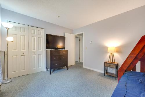 a bedroom with a bed and a flat screen tv at 3 Mi to Ski Slopes - Vermont Mountain Escape! in Mendon