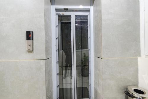 a glass shower in the corner of a bathroom at FabHotel SSR Ikon Suites - Nr Hyderabad Central University, Kondapur in Hyderabad