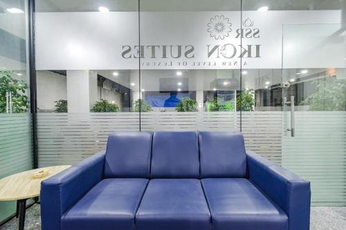 a blue couch sitting in front of a building at FabHotel SSR Ikon Suites - Nr Hyderabad Central University, Kondapur in Hyderabad