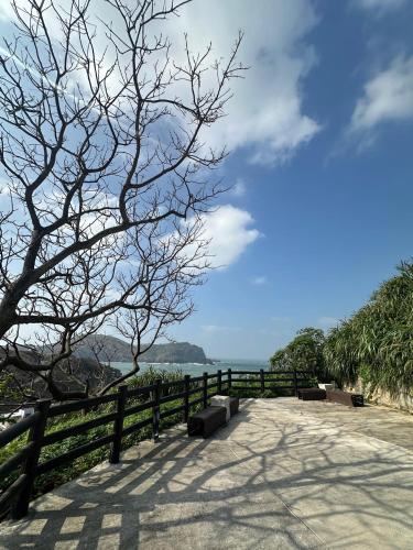a bench on a path next to a fence at Bei Ao Bi Shan Jyu in Dongyin