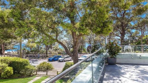 a stairway with a tree in a parking lot at Beachside Escape At Pearl Beach in Pearl Beach