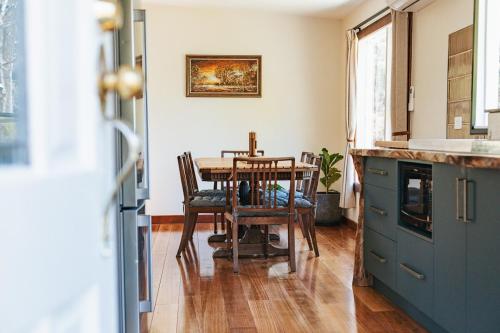 a kitchen with a table and chairs in a room at Fern Mt Field on Tyenna River in Tyenna