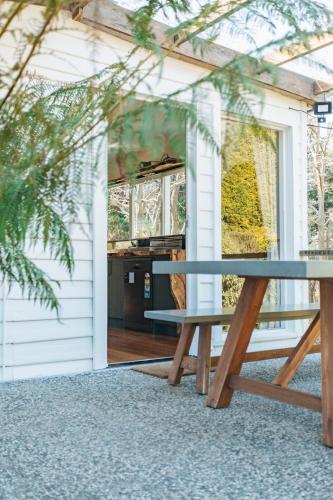 a picnic table in front of a house at Fern Mt Field on Tyenna River in Tyenna
