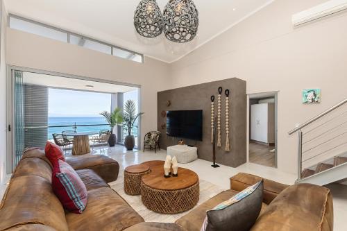 a living room with a couch and a table at The Crystal Apartments in Cape Town