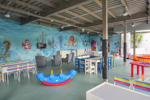 a childrens play room with a colorful wall at Orka Lotus Beach in Marmaris