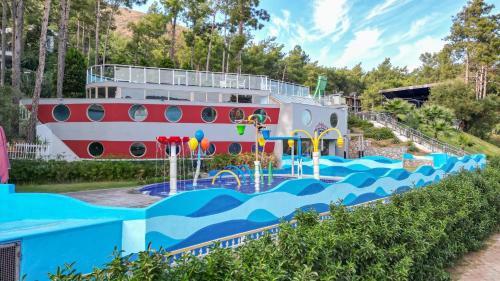 a cruise ship in front of a water park at Orka Lotus Beach in Marmaris