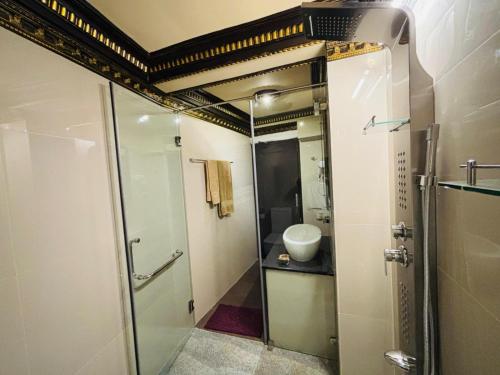 a bathroom with a shower and a sink at Yuki Grand Hotel in Athurugiriya