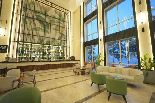 a lobby with couches and chairs and a large window at Orka Lotus Beach in Marmaris