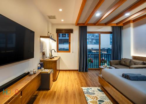 a hotel room with a large flat screen tv at HOLO HAM NGHI SAIGON - Serviced HomeStay in Ho Chi Minh City