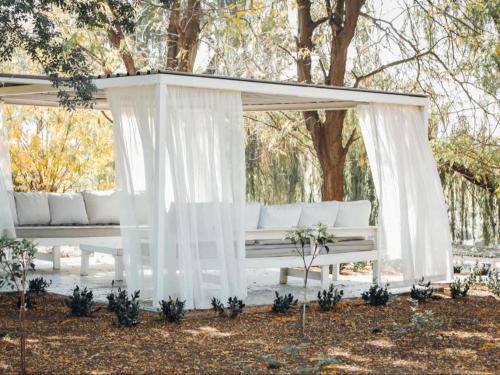 a white gazebo with a white couch at Riverside Escape in Secunda