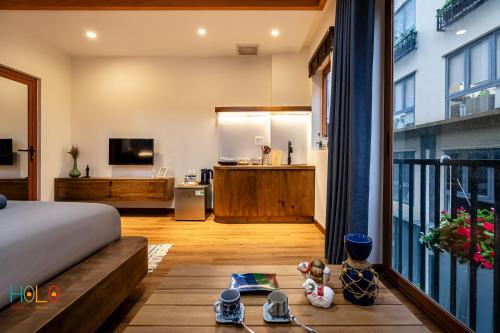 a bedroom with a bed and a living room at HOLO HAM NGHI SAIGON - Serviced HomeStay in Ho Chi Minh City