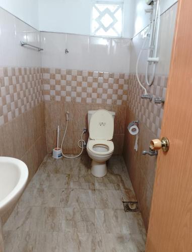 a bathroom with a toilet and a sink at Francy Villa Tangalle in Tangalle