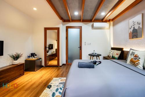 a bedroom with a large bed and a couch at HOLO HAM NGHI SAIGON - Serviced HomeStay in Ho Chi Minh City