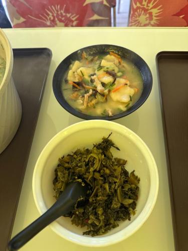 a bowl of soup and a bowl of food on a table at Bei Ao Bi Shan Jyu in Dongyin