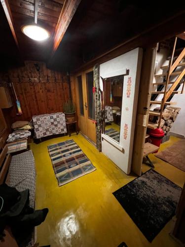 a living room with a yellow floor and a open door at RETRO CHATA Kubínska in Dolný Kubín