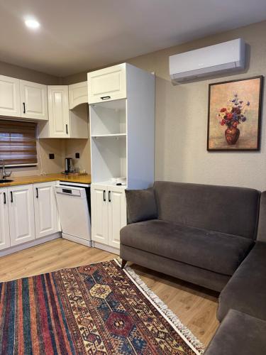 a living room with a couch and a kitchen at Some Hotel Antakya in Hatay