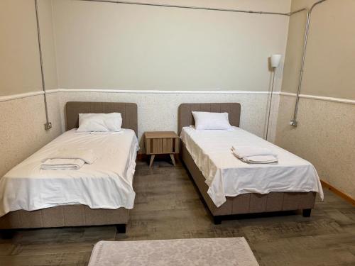 two beds in a hospital room with white sheets at Sunflower 2bedroom Flat North Nicosia-Turkish Side in Nicosia
