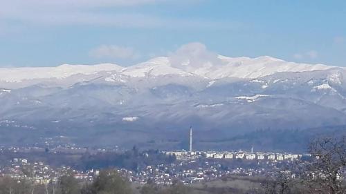 a city with snow capped mountains in the background at ProPolis in Mioarele