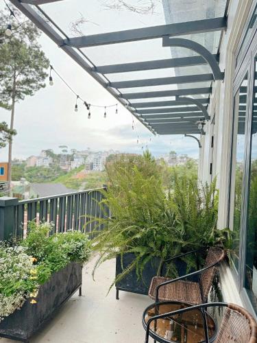 a balcony with plants and awning on a house at Sunflower Garden Homestay Đà Lạt in Xuan An