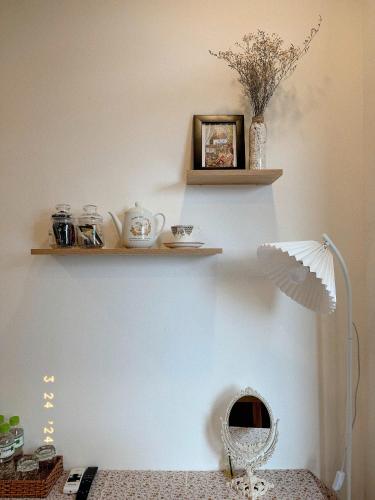 a corner of a room with shelves on a wall at Sunflower Garden Homestay Đà Lạt in Xuan An