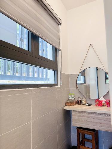 a bathroom with a mirror and a window at Sunflower Garden Homestay Đà Lạt in Xuan An