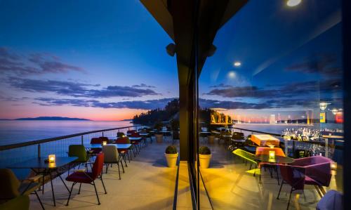 a view of a balcony with tables and chairs at Design Hotel Navis in Opatija