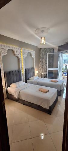 two beds sitting in a room with at Cozy Flat With Sea View in Tangier
