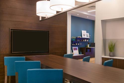 a conference room with a large table and blue chairs at Fairfield Inn & Suites by Marriott Dayton in Dayton