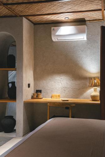 a bedroom with a bed with a desk and ailver at SIVANA, Hotel Boutique with ocean or garden views - Adults only in Uluwatu