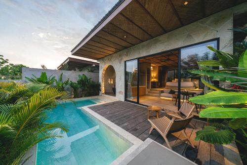 a house with a swimming pool and a patio at SIVANA, Hotel Boutique with ocean or garden views - Adults only in Uluwatu