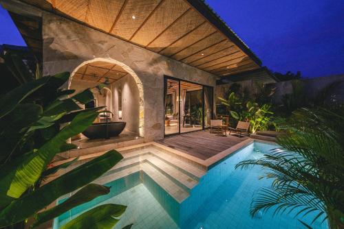 a villa with a swimming pool and a bathroom at SIVANA, Hotel Boutique with ocean or garden views - Adults only in Uluwatu