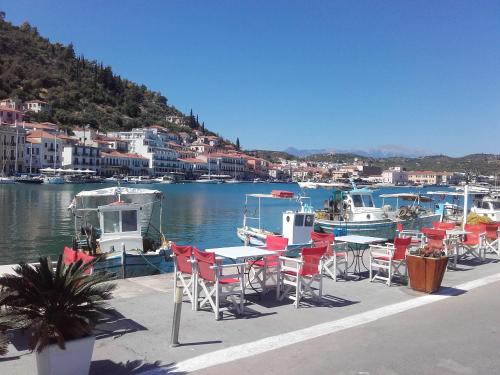 a group of tables and chairs next to a marina at Estia Holiday in Gythio