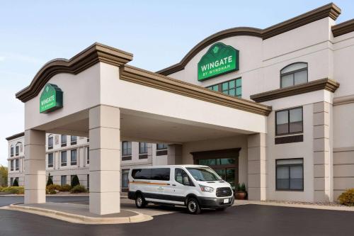 a white van parked in front of a hotel at Wingate by Wyndham Green Bay in Green Bay