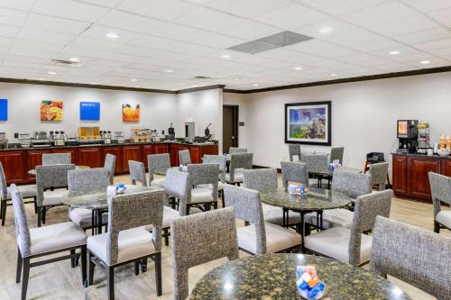 a waiting room at a dental office with tables and chairs at Comfort Inn Monticello in Charlottesville
