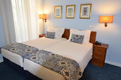Кровать или кровати в номере Hotel Florescente