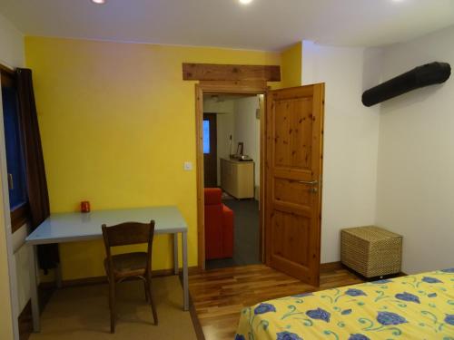 a bedroom with a bed and a desk and a table at Vire de Vie in Villiers