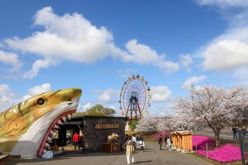 a large inflatable shark at a amusement park with a ferris wheel at Sakuradai House in Ichihara