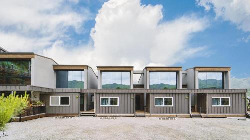 a house with a lot of windows on it at Gapyeong Gently Pension in Gapyeong