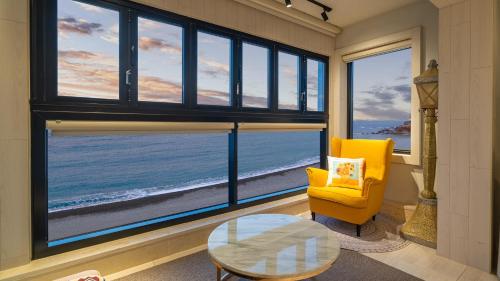 a living room with a view of the ocean at Gyeongju Luna Piena Poolvilla in Gyeongju