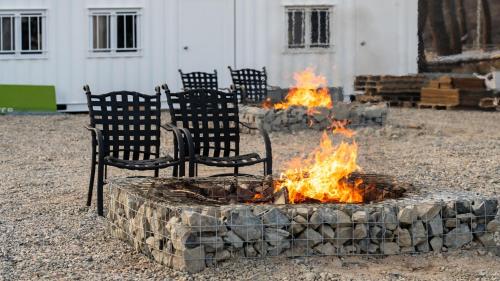 a fire pit with chairs around it in a yard at Gyeongju Luna Piena Poolvilla in Gyeongju