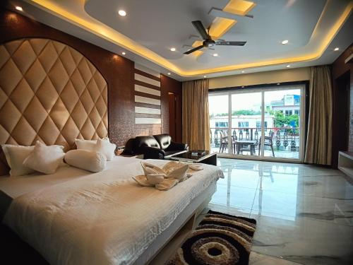 a bedroom with a large bed with a large window at Sagar Kuthi in Mandarmoni