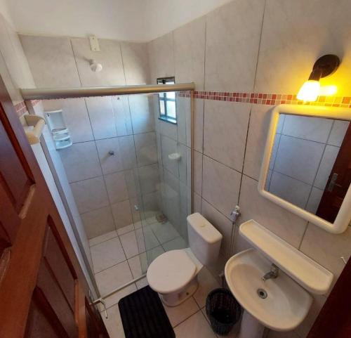 a bathroom with a shower and a toilet and a sink at Pousada Chalet La Pink in Canoa Quebrada