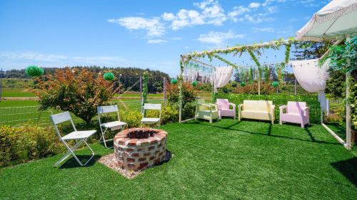 a group of chairs and a gazebo at Taean Yoyo Kids Poolvilla in Taean