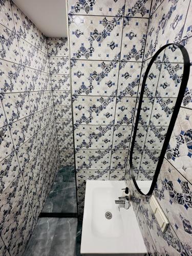 a bathroom with a sink and a mirror at Broken bed hootel in Kaunas