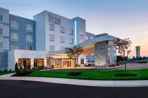 a hotel with a building with a sign on it at Fairfield Inn & Suites by Marriott Harrisburg International Airport in Middletown