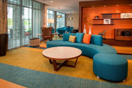 a living room with a blue couch and a table at Fairfield Inn & Suites by Marriott Harrisburg International Airport in Middletown