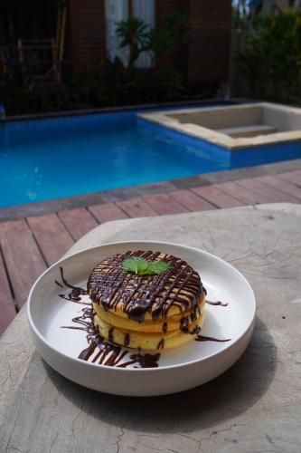 a dessert on a plate on a table at Sadev Resort in Gili Trawangan