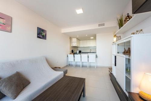 a living room with a couch and a table at Apartment Mojácar - Big terrace in Mojácar