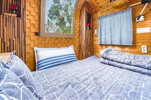 a bedroom with a bed in a wooden cabin at Seogwipo Campa jeju in Seogwipo